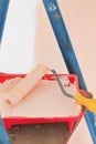 Home wall improvement beige painting by roller Royalty Free Stock Photo