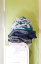 Home wardrobe with different items of clothing. Seasonal clothes sorting. Royalty Free Stock Photo