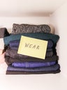 Home wardrobe with different items of clothing. Seasonal clothes sorting. Royalty Free Stock Photo