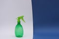 Home water sprayer, green, plastic on a dark blue, white background. . Free space for text Royalty Free Stock Photo