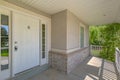 Home with white front door and sunlit porch