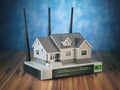Home wireless network. House and wi-fi router on wooden table an
