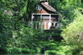 Home in the woods on a sunny day. Overgrown trees hidden away.