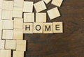 Home word on wood plate abstract background.