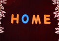 Home word written with different colored letter blocks on a dark background Royalty Free Stock Photo