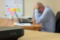 Home working man on computer annoyed at loss of internet signal in Beccles, Suffolk, England