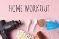 Home workout, lockdown. Therapeutic percussive massage gun, fit meal, pills, sport energy bar on pink background - concept of Royalty Free Stock Photo