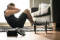 Home workout. Man doing ab training and crunches in living room Royalty Free Stock Photo