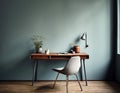 Home workplace with wooden drawer writing desk and grey fabric chair near turquoise wall with copy space. Interior design of