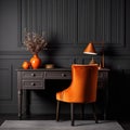 Home workplace with wooden drawer writing desk and orange chair near black wall with wainscoting Royalty Free Stock Photo