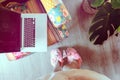 Home workspace: girl in slippers working on her laptop.