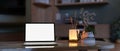 A home workspace at night with a white-screen laptop computer mockup on a marble coffee table Royalty Free Stock Photo