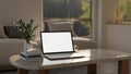 Home workspace, a white-screen laptop mockup on a marble coffee table in a comfortable living room Royalty Free Stock Photo