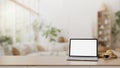 Home workspace, A white-screen laptop on a wooden table in a modern Scandinavian living room Royalty Free Stock Photo