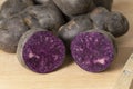 Homegrown organic purple Vitelotte potato in half close up Royalty Free Stock Photo