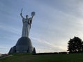 Homeland, high sculpture of a woman. Metal monument against the blue sky. Concept: sights of Kiev