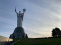 Homeland, high sculpture of a woman. Metal monument against the blue sky. Concept: sights of Kiev