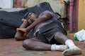 A homeless African American man sleeping on the street Royalty Free Stock Photo