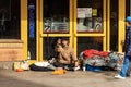 Homeless asks for alms in front of a bank - Bologna Italy