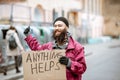 Homeless beggar with cardboard outdoors