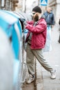 Homeless beggar near the trash containers in the city Royalty Free Stock Photo