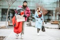 Homeless beggar with passing by business woman Royalty Free Stock Photo