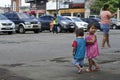 Homeless beggar`s children boy and girl, walking, take care of each other at church yard