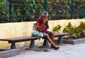 A homeless beggar on a street bench in Playa Las Americas catching a rest while the prosperous world passes him by.