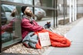 Homeless begging money near the business center Royalty Free Stock Photo