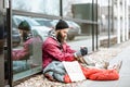 Homeless begging money near the business center Royalty Free Stock Photo