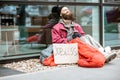 Homeless begging money near the business center Royalty Free Stock Photo