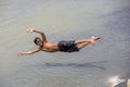 Homeless boy are fun jumping play in Karnafuli River Sadarghat areas, Chittagong, Bangladesh.