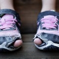 Homeless Child Wearing Old Worn Out Shoes with Holes in them Toes Sticking Out Royalty Free Stock Photo