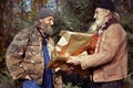 Homeless couple of poor men changing christma gifts in park