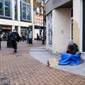 Homeless Destitute Poor Woman Sitting On A Pavement