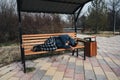 homeless dirty elderly old Caucasian man lies sleeping on park bench in autumn Royalty Free Stock Photo