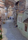 Homeless, dirty woman and her son are liying on street asphalt in Sibiu, Romania