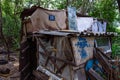 Homeless dweling. Small habitation made from garbage in dirty littered forest Royalty Free Stock Photo