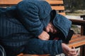 homeless elderly old Caucasian man lies sleeping on park bench in autumn Royalty Free Stock Photo