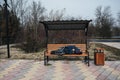 homeless elderly old man lies sleeping on park bench in autumn