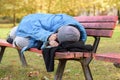 Homeless elderly woman sleeping rough in a park