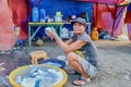 A homeless Filipino woman living in a tarpaulin tent.