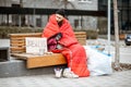 Homeless beggar on the bench near the business center Royalty Free Stock Photo