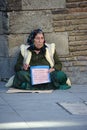 A homeless lady begging for alms in the streets of SEville