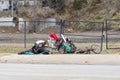 Homeless male laying on the ground with his stuff in Ogden City Utah