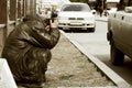 Sad homeless man sitting at the wall in city street Royalty Free Stock Photo