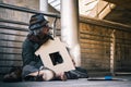 Homeless man on the corner of the walkway street in the city waiting for kindness people give money or food