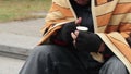 Homeless man counting money and thinking about his life, destitution, poverty