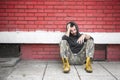 Homeless man drug and alcohol addict sitting alone and depressed on the street Royalty Free Stock Photo