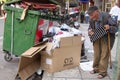 Homeless man looking in a dumpster Royalty Free Stock Photo